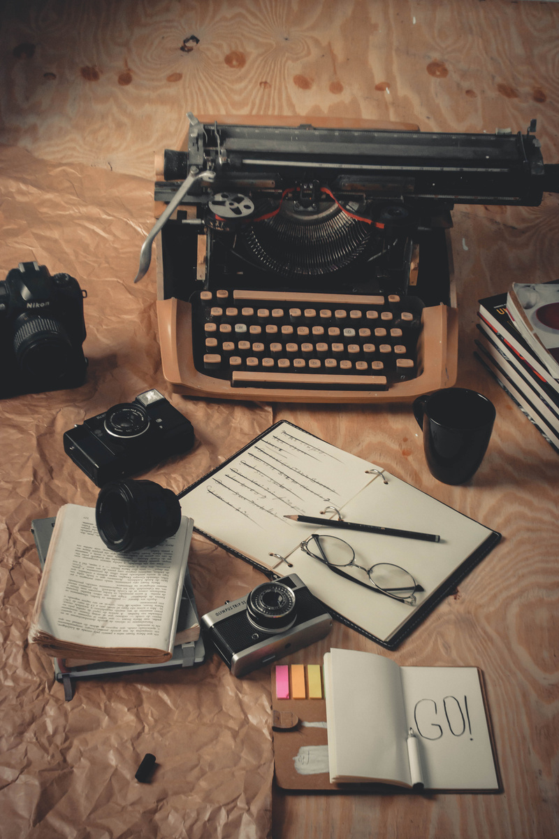 Black and Silver Camera on White Printer Paper